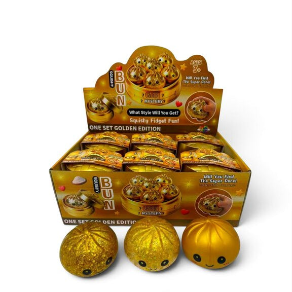 Mystery Dumpling Squishy Gold Edition, zachte dumpling squishy met metallic gouden look in displayverpakking.