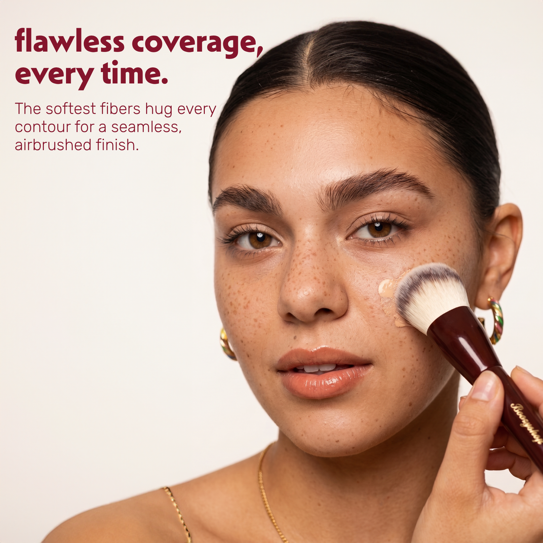 Model applies foundation to the face with the Boozyshop Flawless Contoured Foundation Brush