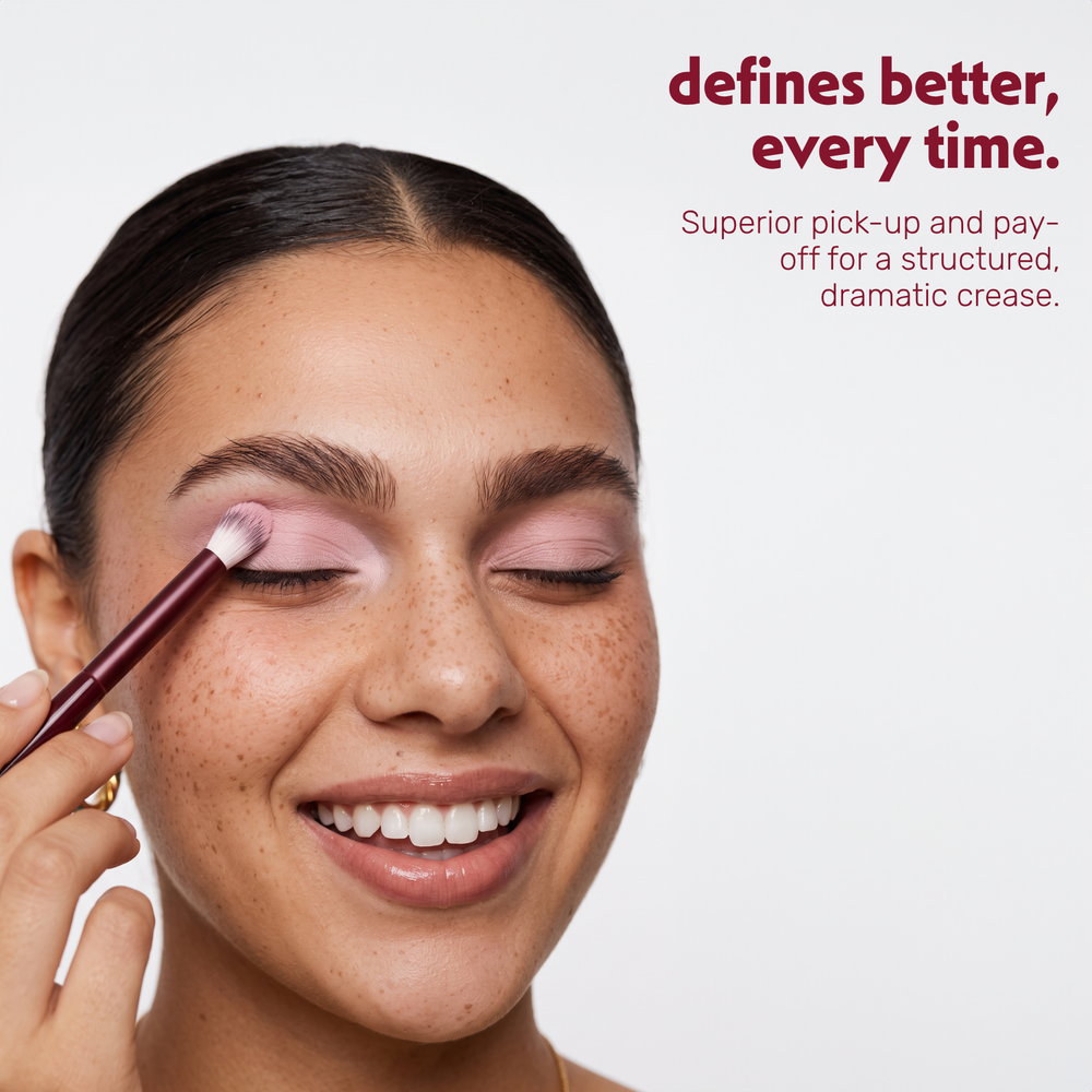 Model applies eyeshadow in the crease with the Boozyshop Flawless Defined Crease Brush