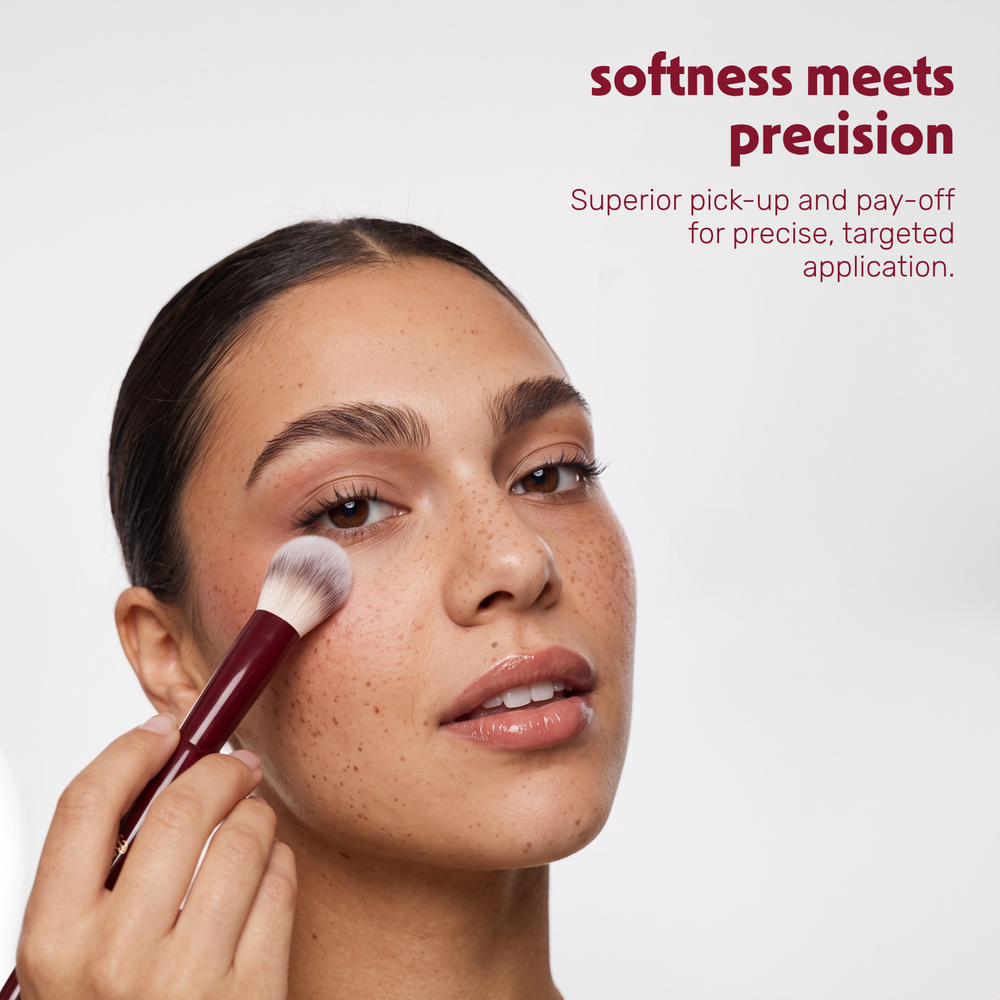 Model applies powder to the face with the Boozyshop Flawless Precision Powder Brush