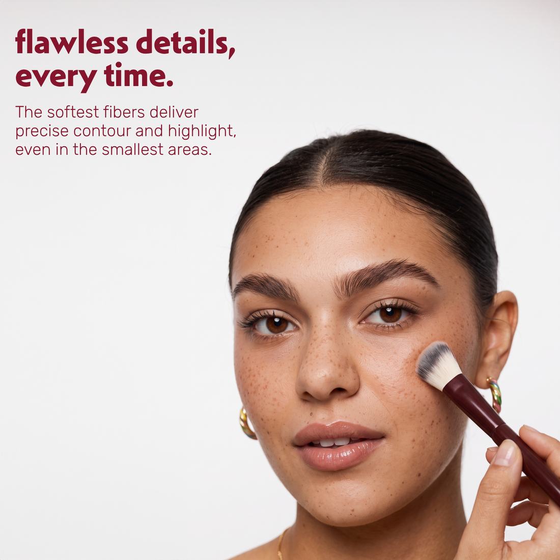Model applies contour to the cheek with the Boozyshop Flawless Small Angle Face Brush
